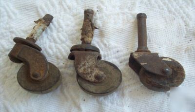 Three antique furniture chasters with wooden wheels